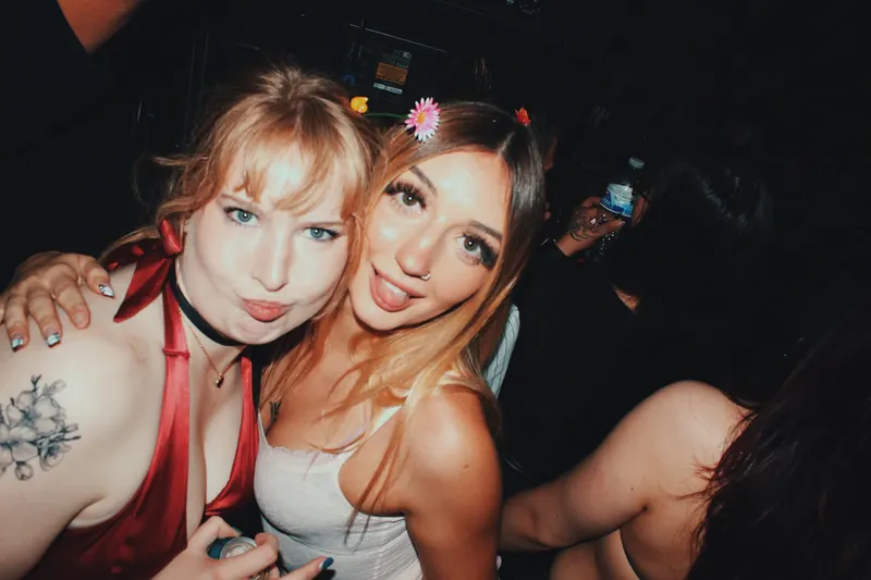 Two guests pose together on the dancefloor.
